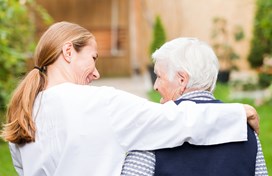 family caregiver with arm around hospice patient