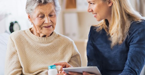 Senior woman and younger woman reviewing documents
